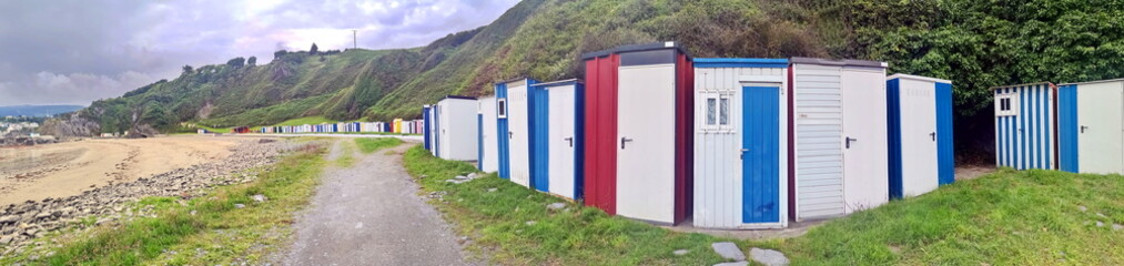 typical colored bathing huts on the beach of Luarca, Asturias, Spain,