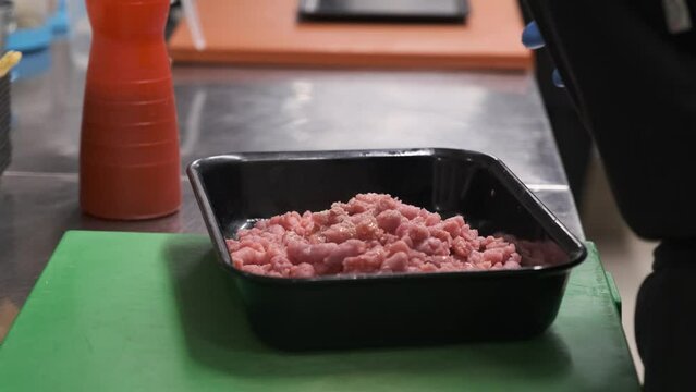 Preparation of meat tartare by a professional chaf in an Italian restaurant kitchen