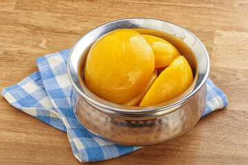 Sweet canned peaches with syrope