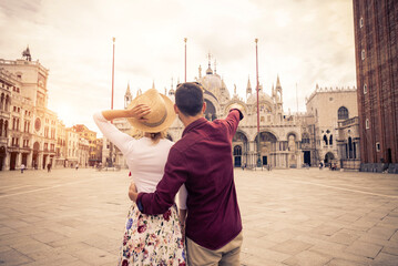 Happy beautiful couple of lovers doing romantic trip in Venice, Italy - Tourists visiting historic...