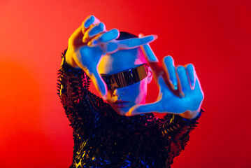 Beautiful woman with stylish clothes - Futuristic portrait of young female with colorful lighting, metaverse and creative fashion concepts