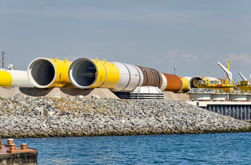 Rotterdam, The Netherlands, August 23, 2022: large tubular parts of future offshore wind turbines...