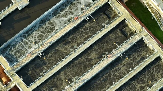 Aerial view of modern water cleaning facility at urban wastewater treatment plant. Purification process of removing undesirable chemicals, suspended solids and gases from contaminated liquid