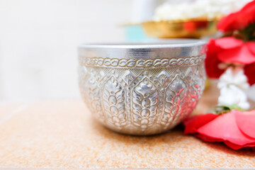 Thai water bowl with jasmine and roses.