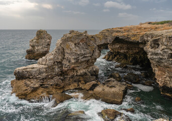 a stone arch over the sea