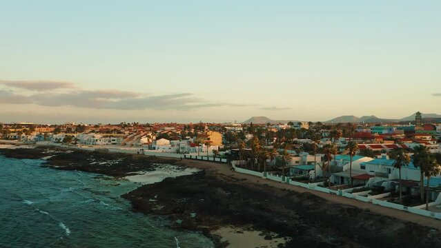 Corralejo aerial cityscape, port city in Fuerteventura, beautiful view of streets buildings on Canary islands, Spain. Resort town. Travel addict. Paradise touristic spot. Sunset. Ocean shore.