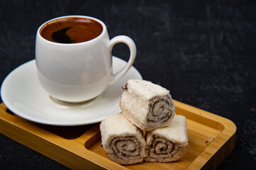 Turkish Delight and Turkish coffee in wooden plate on black background