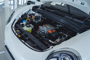 Electric vehicle with open hood and details of electric car engine - obrazy, fototapety, plakaty