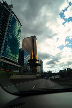 Skyscrapers under dark clouds, high-rise office buildings in Sydney. Shots taken from inside of the car