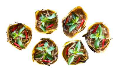 Isolate top view of curried fish wrapped in banana leaves and steamed banana.