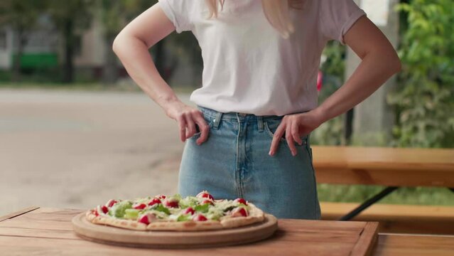Portrait of frustrated woman in white shirt turning out empty pockets, worrying about debts, no money for food.