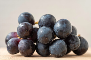Black grapes, close up view, natural light. 