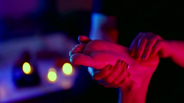 foot massage in traditional thai salon, relax in spa center, closeup view of foot in female hands