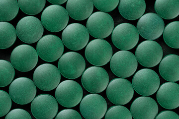 green pills spirulina. macro photo of green pills