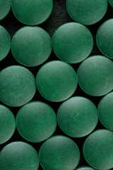 green pills spirulina. macro photo of green pills