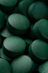 green pills spirulina. macro photo of green pills