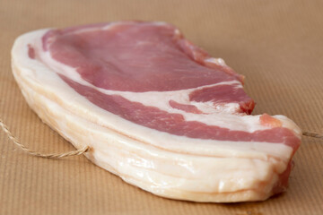 Raw smoked thick cut bacon slices wrapped in brown paper with string, Eco friendly packaging