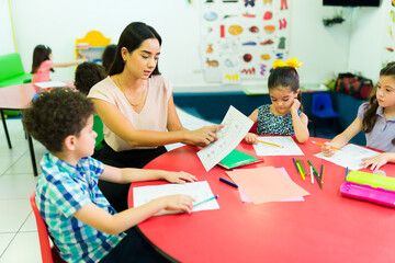 Preschool students learning with a dedicated teacher in kindergarten