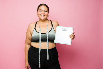 Cheerful overweight woman happy losing weight with diet and exercise