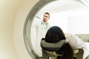 Rear view of a patient getting a computed tomography with a doctor