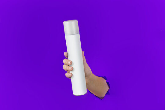 Cosmetic or Perfume Advertisement. Ready to use Item for Branding. Violet Chroma Isolated Background  Photo for design. Clean Bottle Spray Flacon in the Hand.