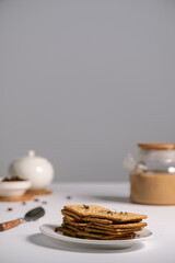 cracker with cereals and bran, diet cookies, delicious breakfast and healthy food, sugar-free dry biscuits, coffee with milk, dill cracker, on a light background, space for text 