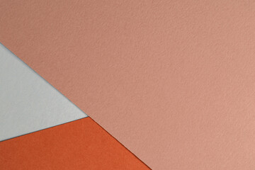 Fototapeta premium Abstract background from craft paper in pink, orange and white colors. Colored paper texture background