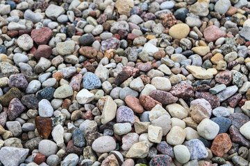 Textured background of stones of different colors close-up. Stone texture. Soft focus