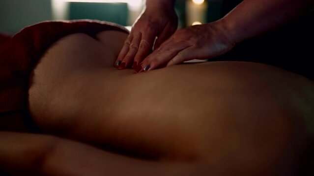 relax massage in spa salon, closeup view of masseuse hands on female back, enjoy and recovery