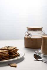 Fototapeta na wymiar cracker with cereals and bran, diet cookies, delicious breakfast and healthy food, sugar-free dry biscuits, coffee with milk, dill cracker, on a light background, space for text 