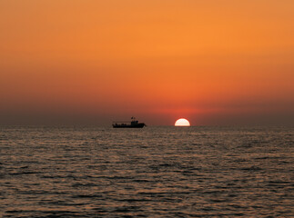 Beautiful seascape at sunset day in summer season. Pleasure boat on the horizon