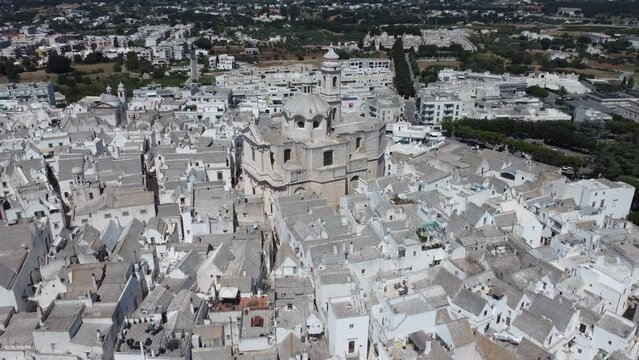 Aerial shot with drone of Locorotondo the white city in the Itria valley, Puglia, southern Italy.