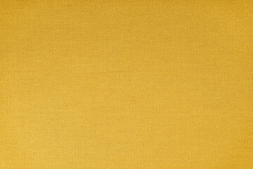 Texture of natural yellow fabric or cloth. Fabric texture diagonal weave of natural cotton or linen textile material. Blue canvas background. Decorative fabric for curtain, furniture, walls, clothes