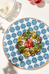 Grilled vegetables on light background with shadows. Salad with grilled zucchini, eggplant and tomatoes. Aesthetic composition with bbq vegetables. Vegan food. Grilled vegetables in Summer menu.