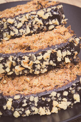 Pastry made of zucchini with nuts and raisin on plate. Delicious dessert
