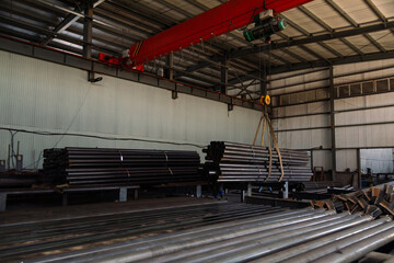 Stainless steel pipes of metal stacked up in a warehouse