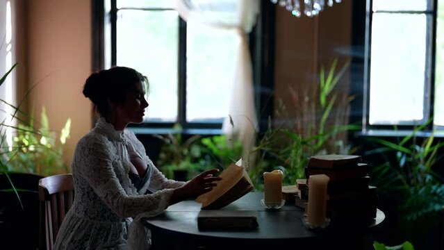 beautiful lady is sitting in vintage room of old noble estate, reading old love novel book