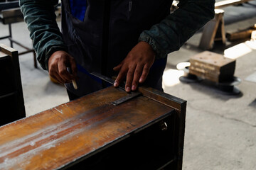 Close up hands of engineer on steel bar taking measurements