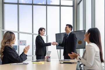 Business group in meeting having hand shake for business deal agreement or celebrating success in boardroom modern office