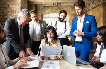 Authoritative business woman consulting his international team to facing the energy global crisis - Group of multiethnic people working on renewable and sustainable power