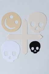 smiley and skulls with paper cross