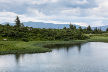 The water surface of a turbulent lake against the background of the Gorgan mountain range