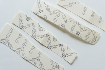 paper with decorative pattern (torn, ivory)