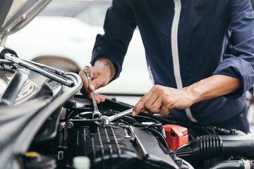 Automobile mechanic repairman hands repairing a car engine automotive workshop with a wrench, car service and maintenance,Repair service.