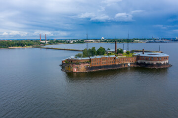 Fototapeta na wymiar Aerial view of Fort Peter the First Citadel in Kronstadt. Kronstadt defensive fortress made of red brick. The waters of the Gulf of Finland, the movement of ships