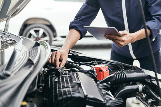 Automobile mechanic repairman hands repairing a car engine automotive workshop with a wrench, car service and maintenance,Repair service.