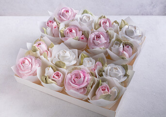 zephyr bouquet of flowers in a pink box on a light background