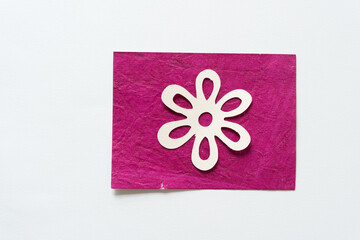 paper flower isolated on pink and white paper