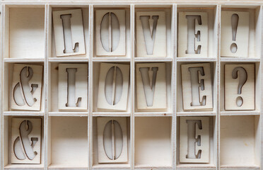 love! & love? @ letter o and e in a shallow wooden box