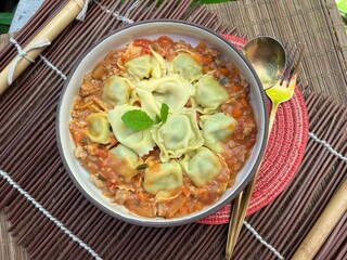 Ravioli stuffed with chopped spinach Parmesan Cheese and Ricotta Cheese with Stir Fried Pork with Sour Sauce